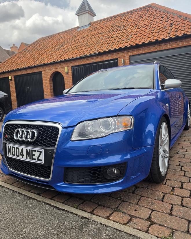 A blue Audi RS4 after detailing, front three-quarter view showing a deep, glossy finish
