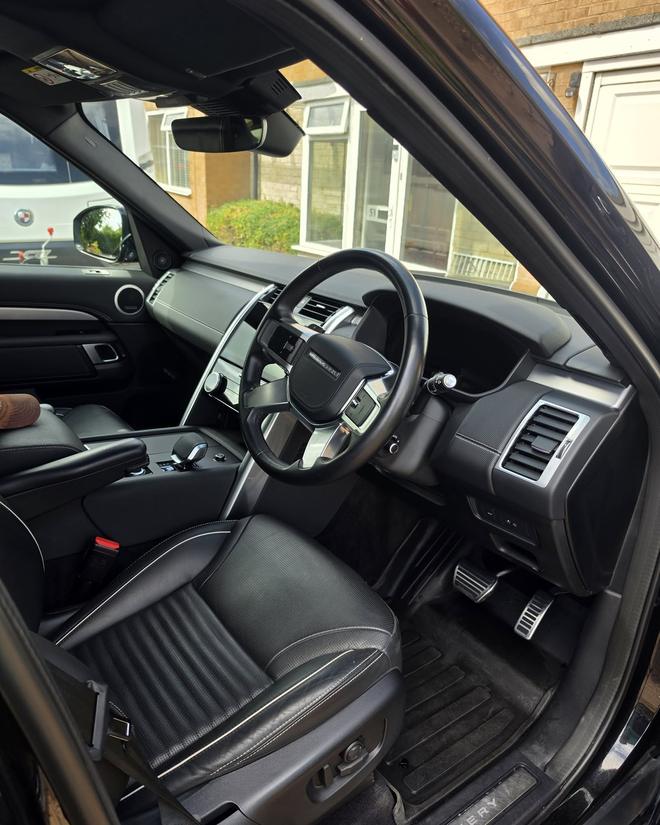 Spotless black leather interior of a Land Rover Discovery after a full valet