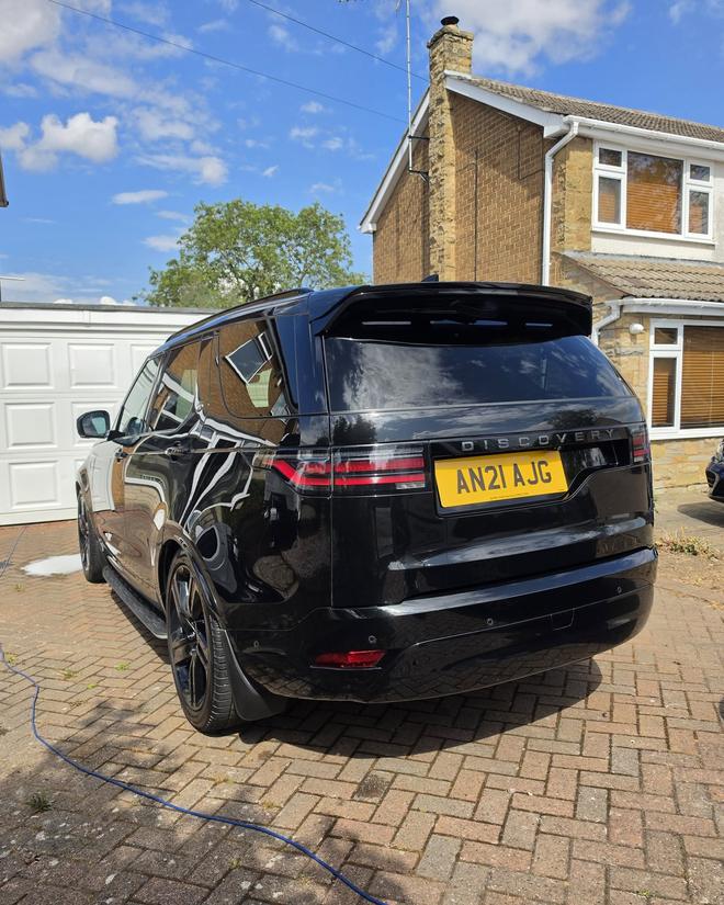 Rear view of a black Land Rover Discovery showing a deep, glossy finish