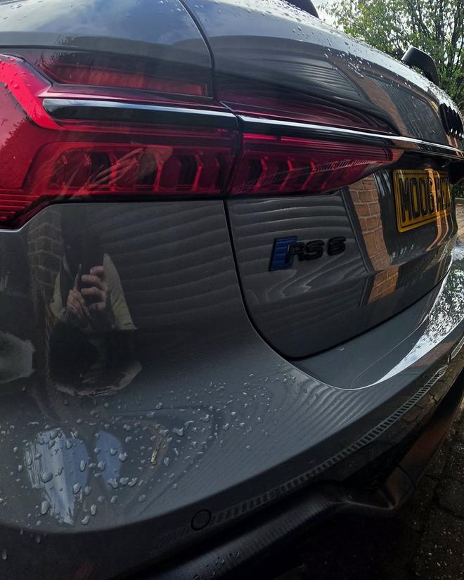 Close-up detail shot of an Audi RS6 tail light with water beading after a wash