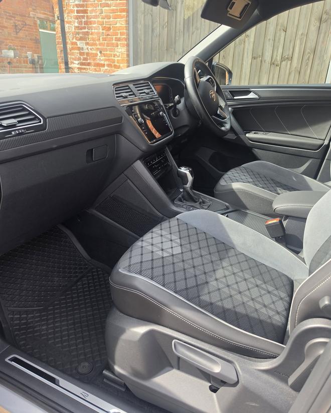 A matte grey BMW X4 after detailing, front three-quarter view