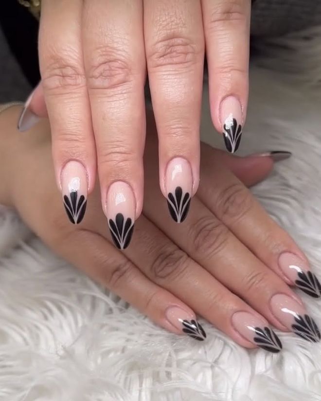 Black art-deco fan design French tips on almond nails